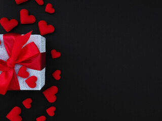 valentine love heart gift background with red present elements on black background clean copy space, and a festive holiday mood, design for Black Friday sale