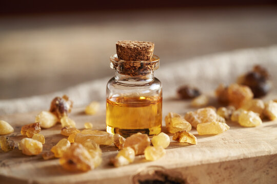 A bottle of frankincense essential oil with frankincense resin