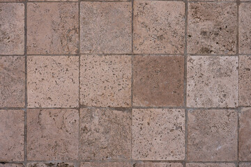 Fototapeta premium Close-up of natural stone floor tiles in earthy tones 