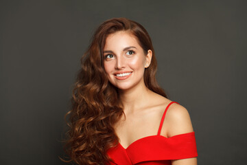 Studio portrait of woman with long hair and make-up on black background. Gorgeous woman with curly hairstyle