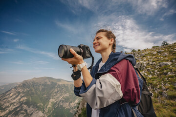 Outdoor travel lifestyle woman photographer shooting photo camera, travel adventure concept