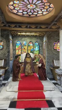 Moses Holding the Ten Commandments in a Chapel with Stained Glass Windows
