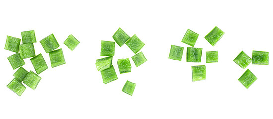 Green bell pepper pieces isolated on a white background, top view. Green paprika cubes.