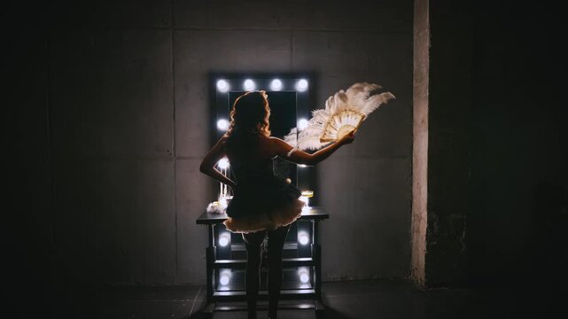 Silhouette beauty retro lady looking into mirror hand holding waving fan white white ostrich feathers. sexy woman burlesque show dancer actress back view. Flapper girl 20s roaring twenties old style