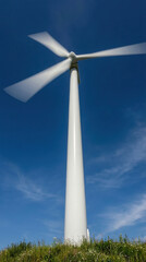Wind turbine against blue sky on a sunny day