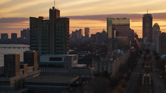 Aerial view of the Prudential Tower and Hancock Building piercing the sunset, casting long shadows across the cityscape, Boston, Massachusetts, United States.