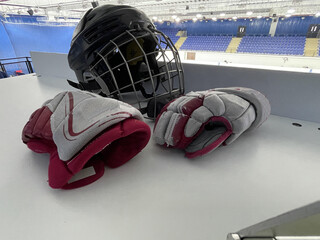 hockey helmet and gloves on the tabel in ice arena
