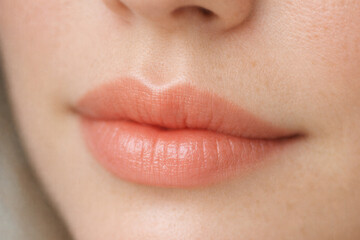 Extreme Close Up Of Natural Female Lips With Peach Lip Gloss
