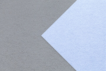 Textured gray paper background, half two colors with pastel blue arrow, macro. Template with copy space for banner