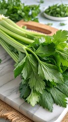 Fresh Celery Stalks on White Marble Cutting Board