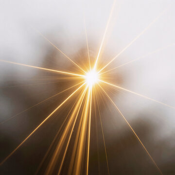 Glowing light gold star beam overlay on white background creates a magical, dynamic sparkle for flash or abstract streak effects