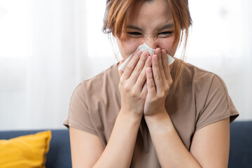 Illness Reflection: A young individual with a look of discomfort, holding a tissue up to their nose. The scene is of health, with a focus on seasonal illness or allergies.