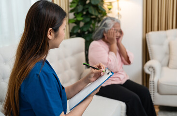 Supporting and Comforting: A caring caregiver attentively listens to and notes down the sentiments of an elderly individual, embodying a gentle atmosphere of support and empathy.