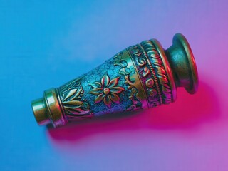 A beautifully crafted, ornate Purim grogger with floral designs. The grogger is used during the reading of the Megillah in Jewish celebrations.