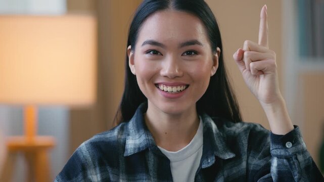 Portrait Asian Korean woman thinking having idea creative smart female raising index finger at home pensive lady remember solution deciding problem thoughtful expression inspiration decision pondering
