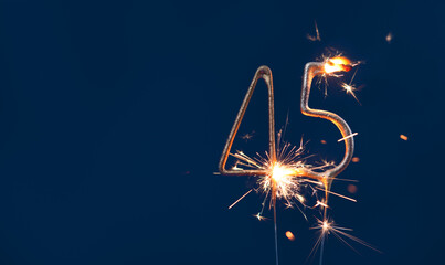 45 years anniversary celebration festive background made with Bengal fires in the form of number Forty five.