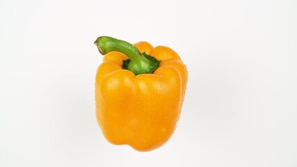 Single yellow bell pepper rotating on white background. Fresh wet vegetable ingredient. - Powered by Adobe