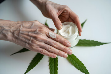 Hands applying skincare cream with hemp leaf base