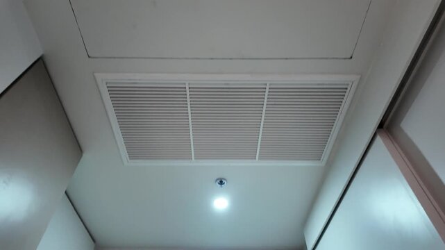 Camera video of ceiling light and air vent in modern room