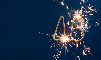 46 years anniversary celebration festive background made with Bengal fires in the form of number Forty six. Copy space.