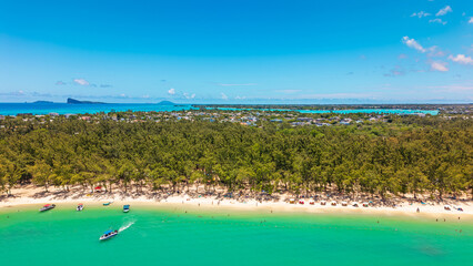 Stunning panoramic aerial view of a tropical Mon Choisy Beach sand beach with turquoise lagoon...