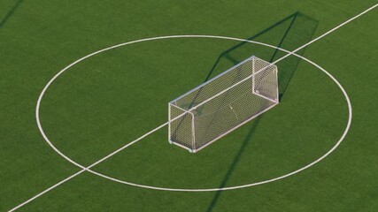 Aerial footage of training football goal on artificial turf, drone circling left over empty sports field
