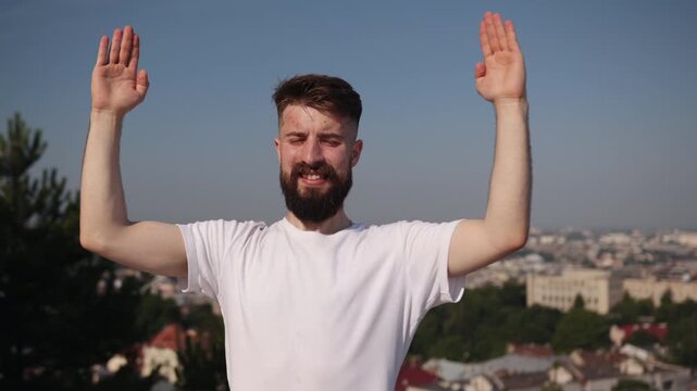 Mountain top, Balance pose, Yoga journey. Clad in white and black, young man practices yoga on hilltop purple mat, highlighting concentration and well-being in natural setting.