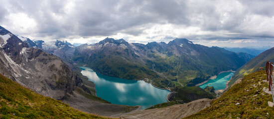 Austria Alps landscape with alpine meadows, forested slopes, and rugged mountain peaks under open sky. High altitude terrain showing natural scenery, geology, outdoor environment, European mountain re