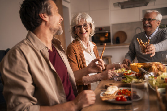 Multi-generation family enjoying happy lunch together at home