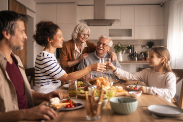 Multi-generational family celebrating together at home lunch
