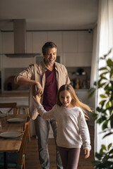 Fototapeta premium Father and daughter dancing together at home