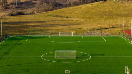 Top view aerial of football training pitch with artificial turf, suitable for backgrounds and layouts