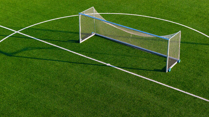 Close aerial detail of football goal structure and net on artificial turf training ground
