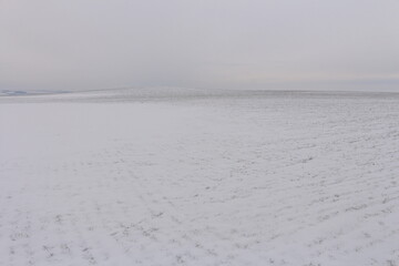 A snowy landscape with a body of water