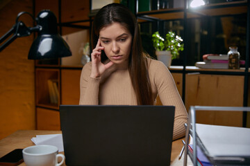 Woman experiencing digital fatigue while working late on laptop. Concept of screen overuse, employee burnout prevention, remote work challenges, productivity loss in digital environments.