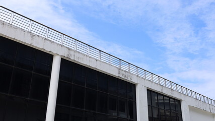 Rooftop railing. Railings on rooftops and balconies of tall buildings or skyscrapers in a low view against a dramatic sky background with selected focus.