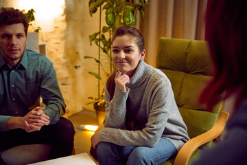 Woman listening attentively during mental health group discussion. Concept of emotional awareness, active listening, stress recovery, burnout therapy, mental balance, supportive dialogue.