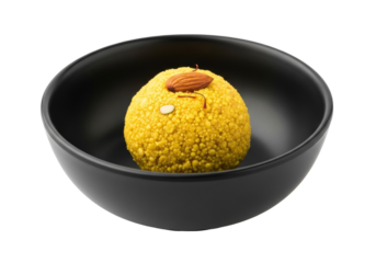besan ladoo in a black bowl with almond topping, indian festival dessert