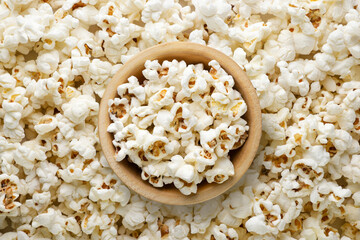 Popcorn in a wooden bowl background. Top view