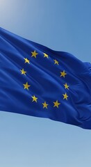 European Union Flag Waving Against a Clear Blue Sky.