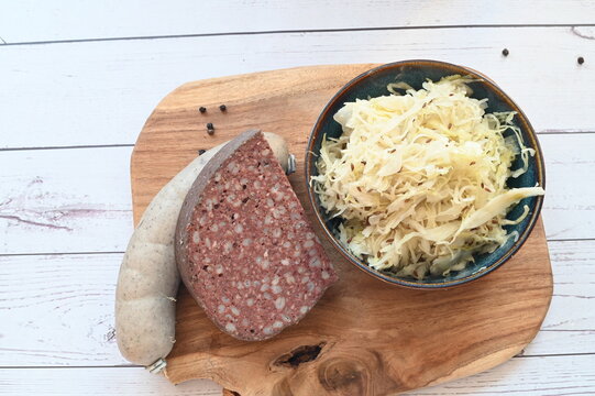 Close-up view of traditional Czech blood sausage (jitrnice) and pork offal sausage (jelita) showcasing authentic butcher products and classic slaughterhouse cuisine. Detailed texture of sausages 