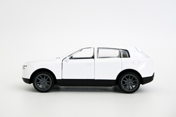 Toy white car isolated on white background, side view