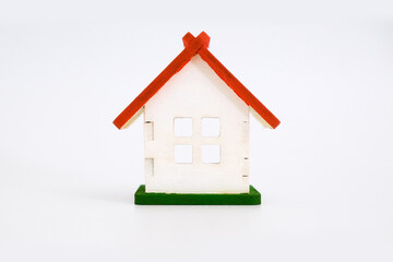 Wooden toy white house with red roof isolated on white background