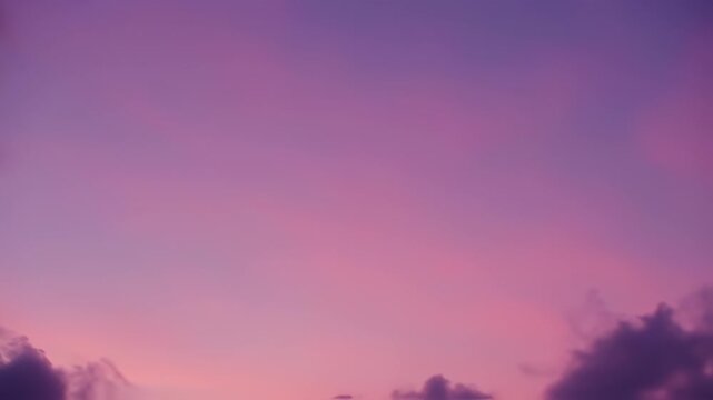 A gradient sky is filled with purple and pink, suggesting a dusk or dawn scene with clouds