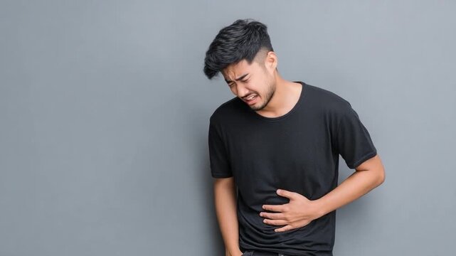 Pain's Grips: A man, writhing in discomfort, clutches his stomach, embodying the anguish of stomach pain or a related health issue. 
