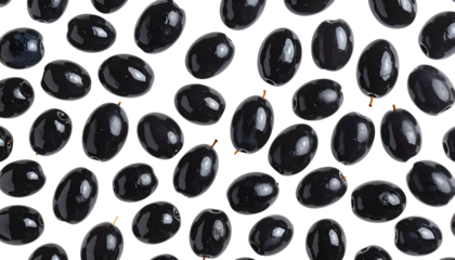 Overhead shot of numerous glossy, dark black olives scattered across a white background