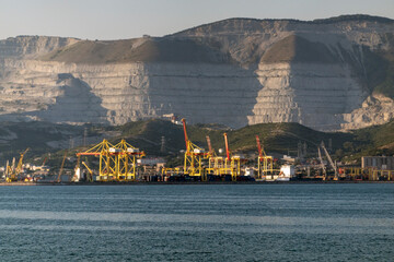 August 22 2025 View of Novorossiysk port Russia with cargo ships and cranes on the coastline. Industrial maritime scene on the Black Sea