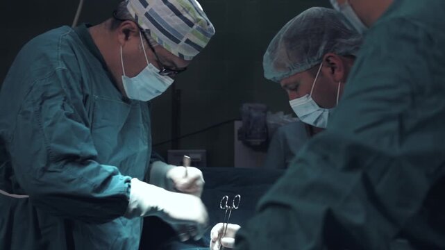 ASurgeon and medical team suturing patient's incision during surgery in operating room