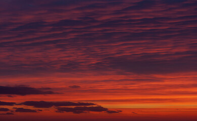 A vivid sunset with layered clouds in hues of violet, crimson, and gold. The dramatic yet silent sky suggests transformation and emotional depth, suitable for covers in literary fiction, existential 