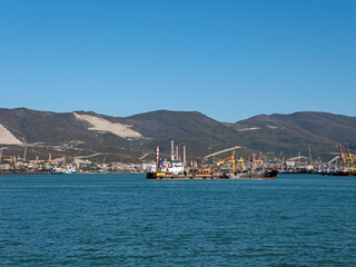 August 22 2025 View of Novorossiysk port Russia with cargo ships and cranes on the coastline. Industrial maritime scene on the Black Sea